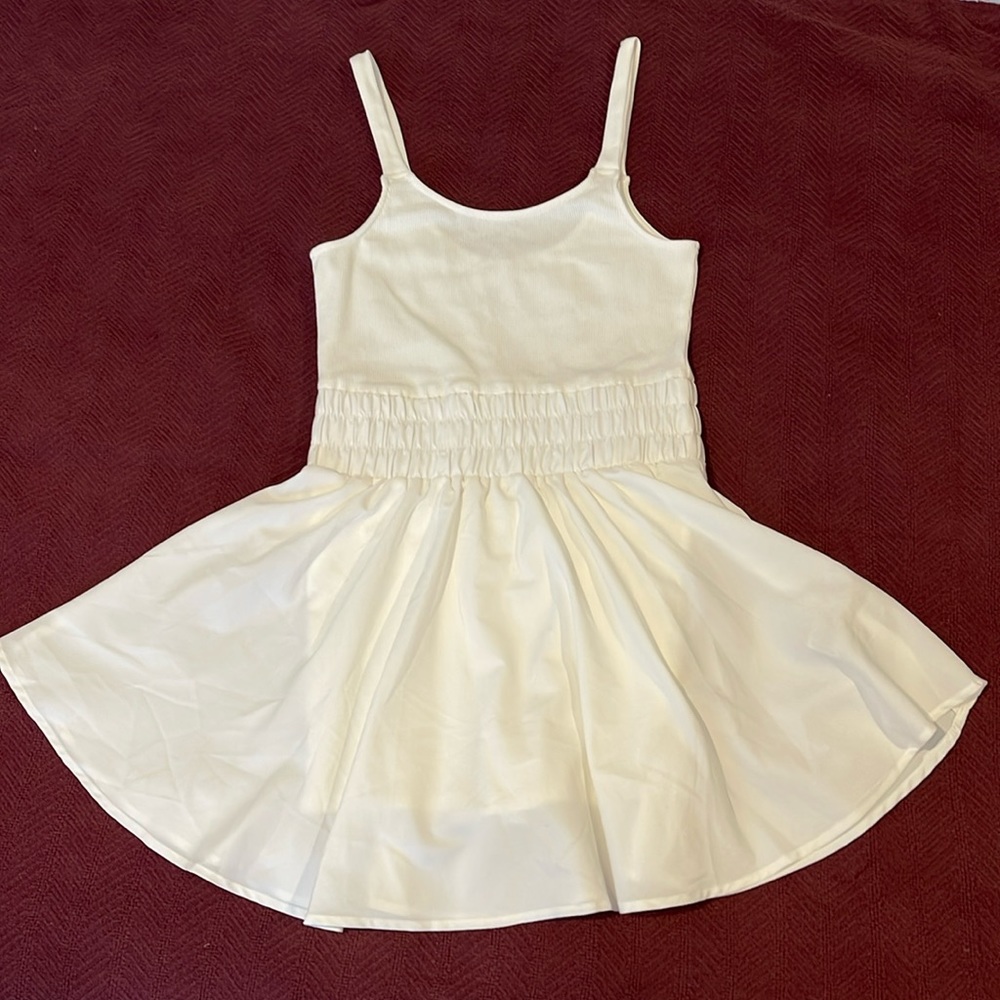 White sport romper with skirt. Size medium.